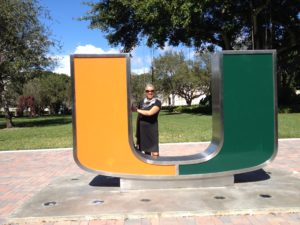 DR Grant standing in front of the UM logo statue