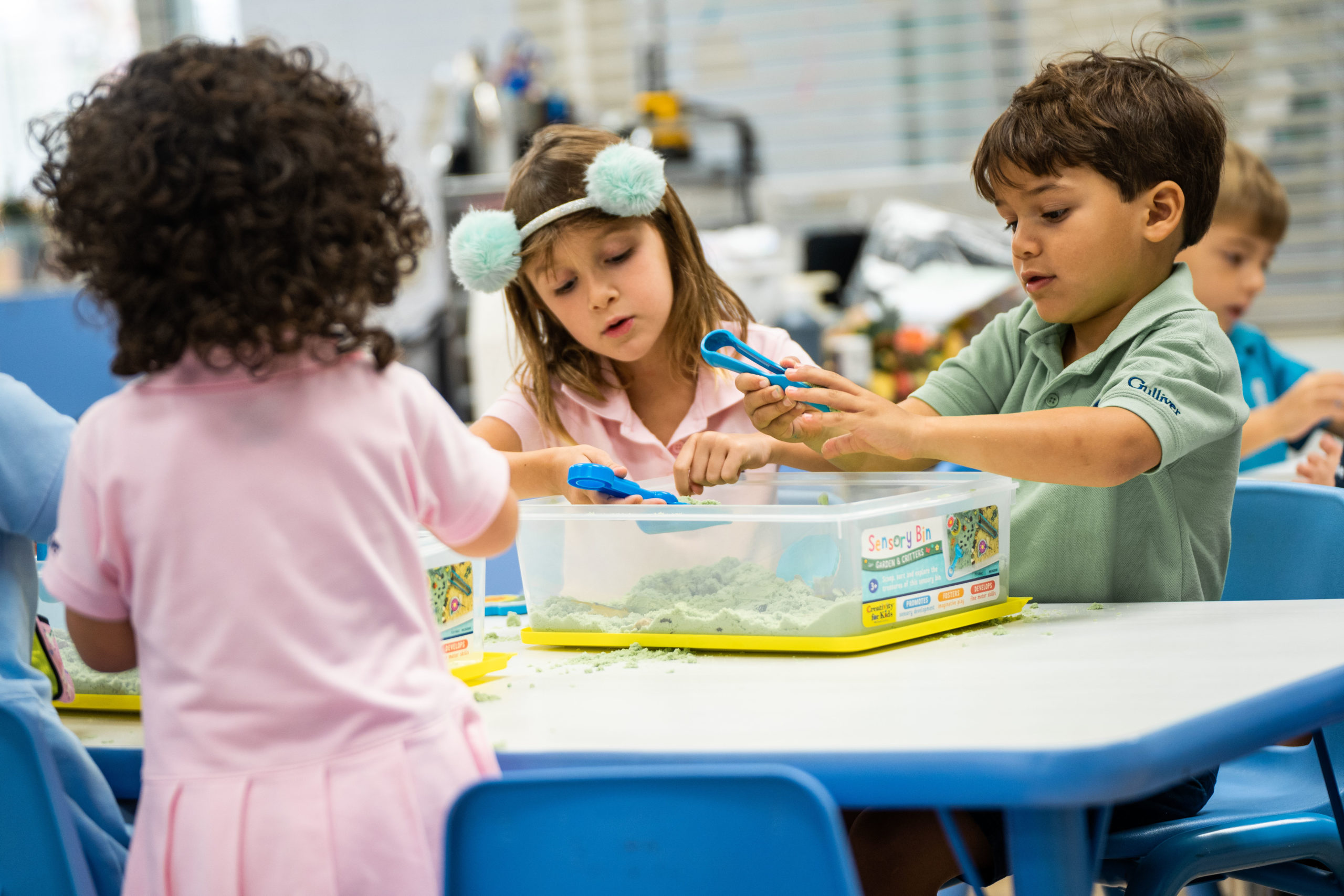 Primary students playing with sand during art