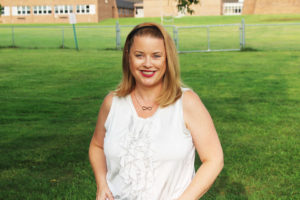 Woman standing in front of lawn