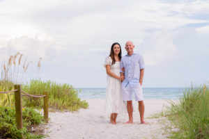 Two people standing on the beach