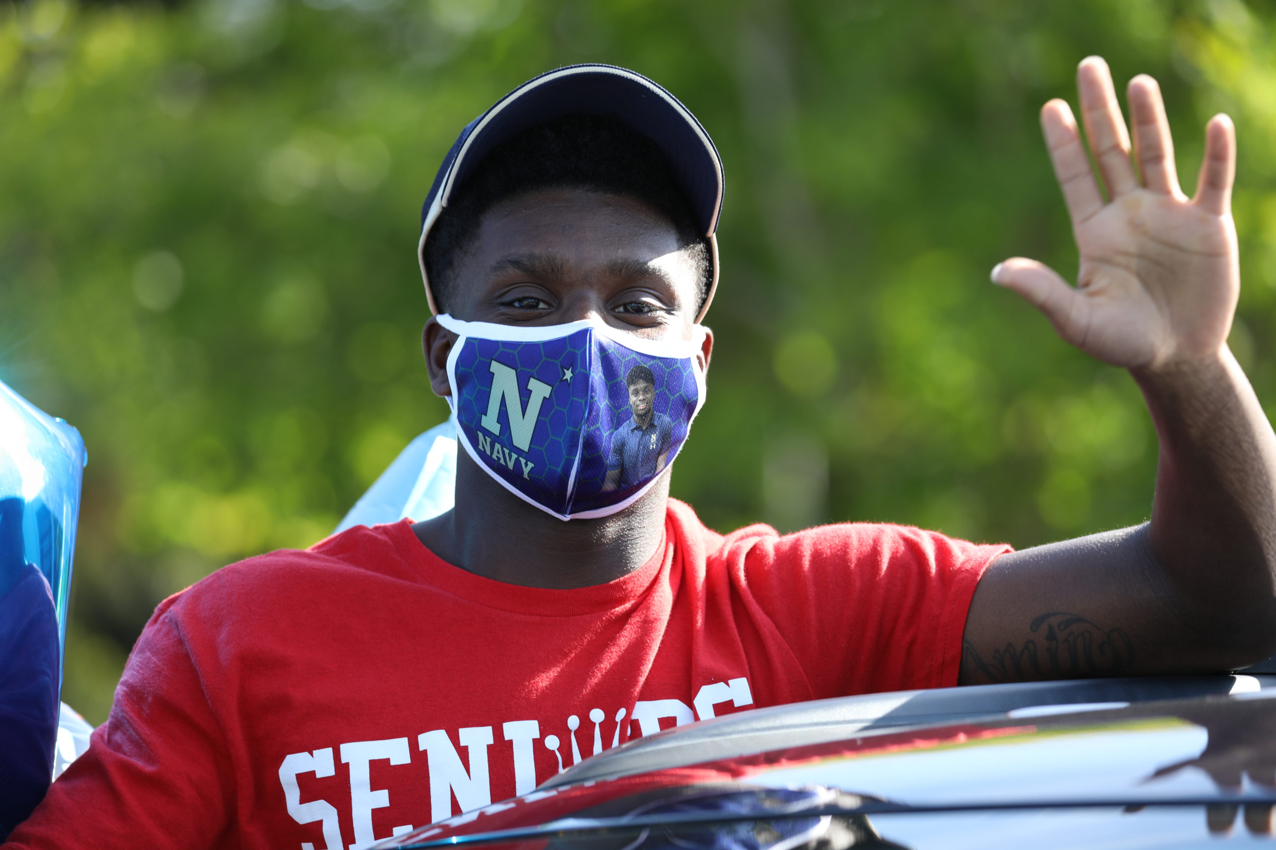 Amin Hassan waving at senior parade