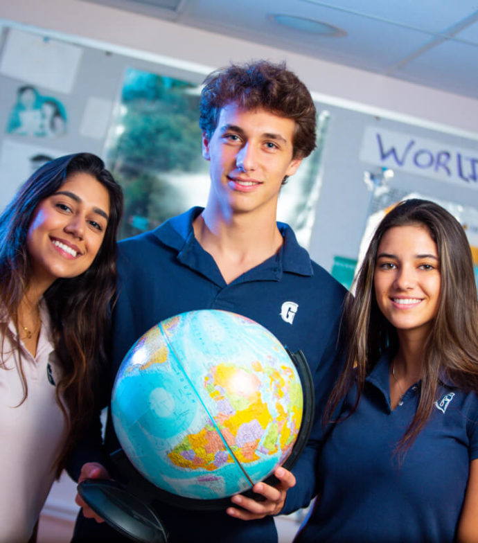 Three students with a globe