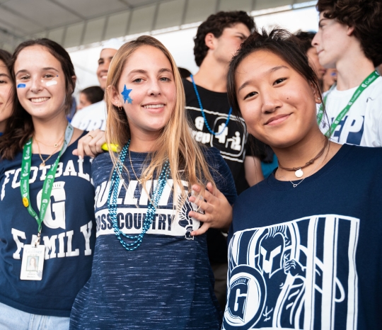 Students at football games wearing school colors