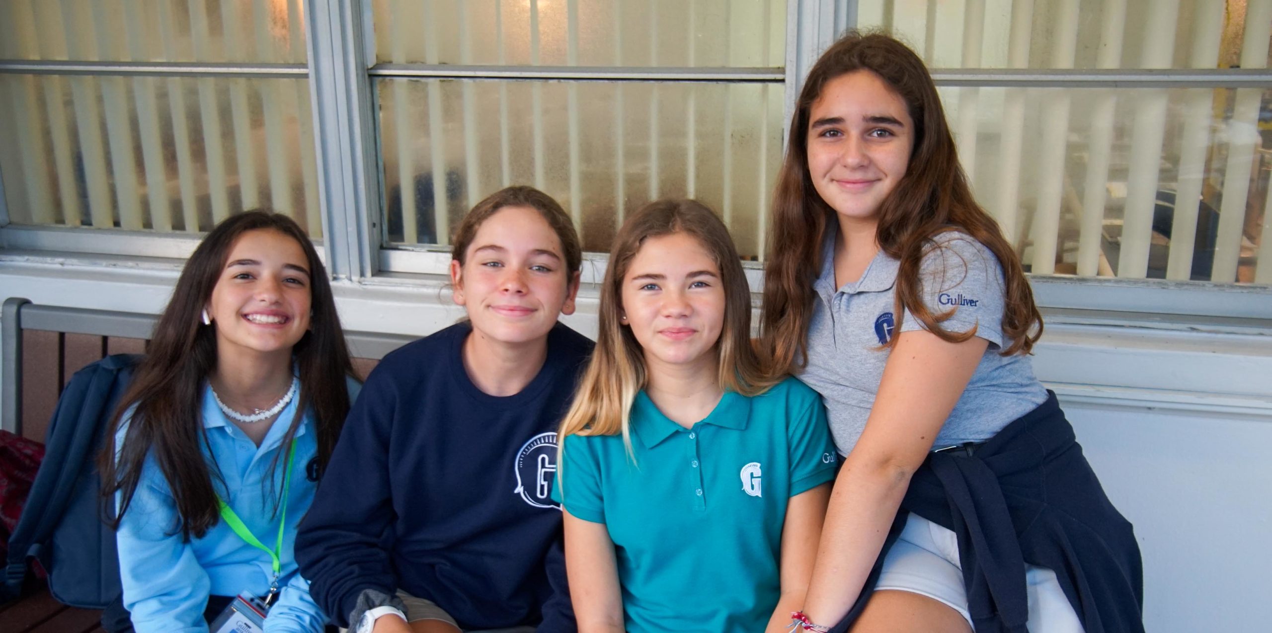 Four girls smiling outside