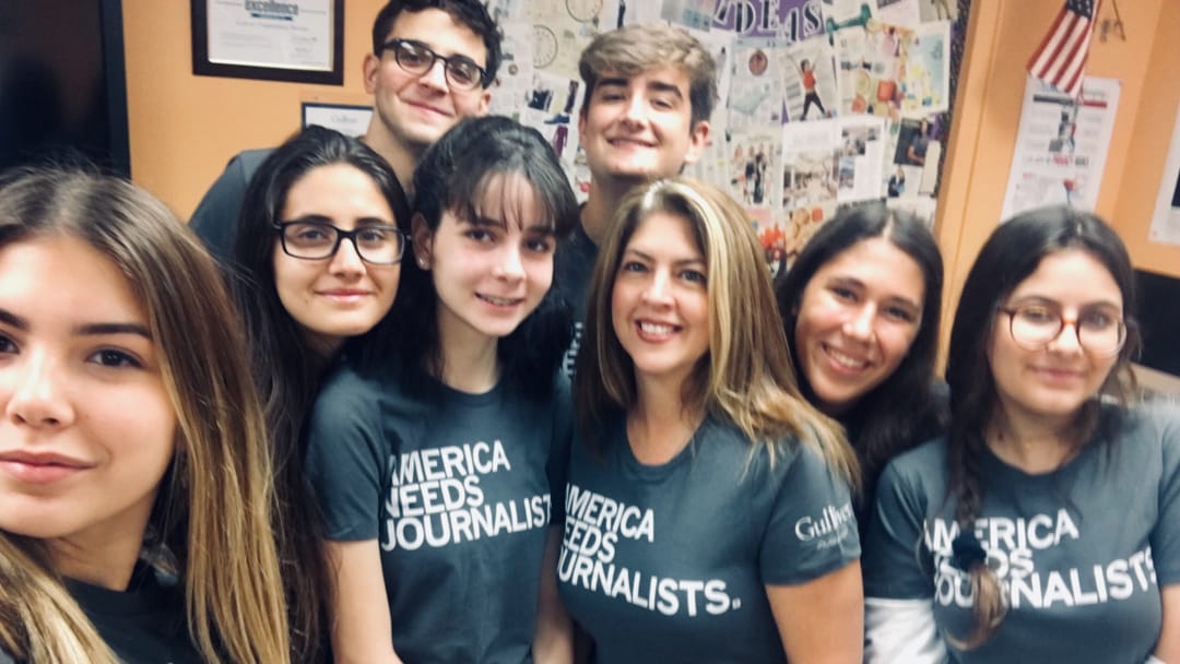 Group of student journalist wearing matching shirts