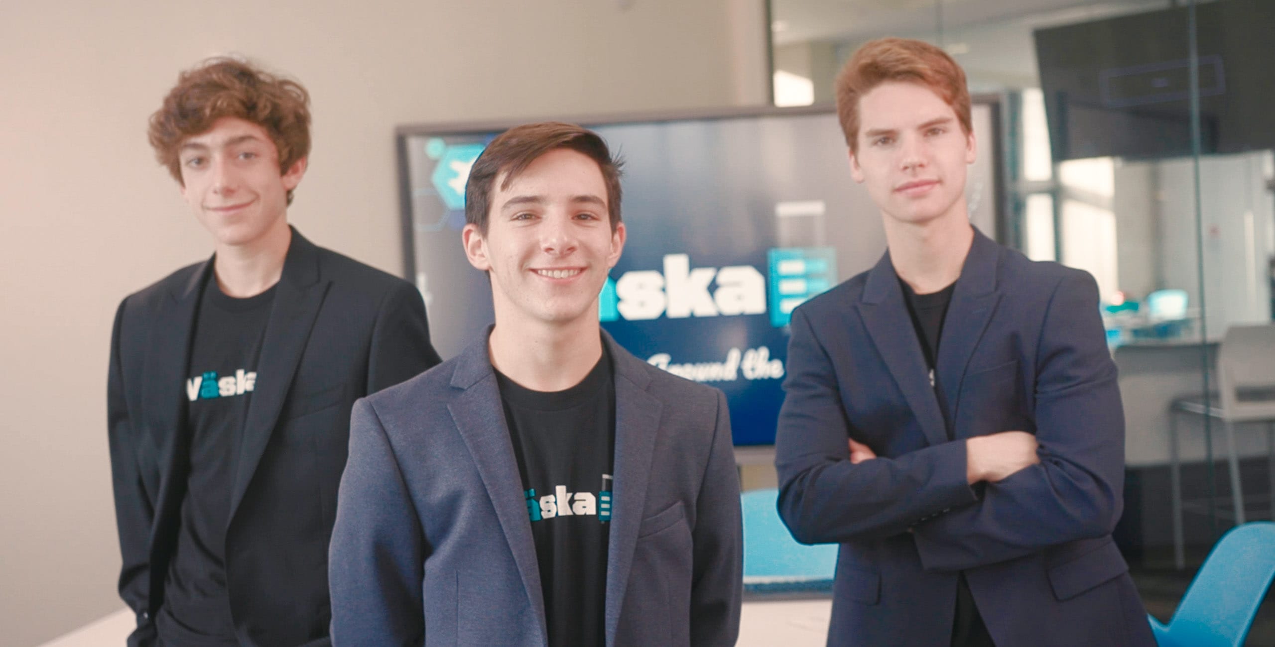 Three International Business & Entrepreneurship students standing with suits on