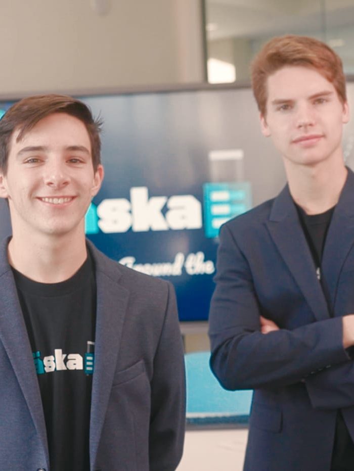 Three International Business & Entrepreneurship students standing with suits on