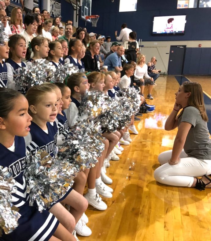 Coach talking to the youth cheer squad