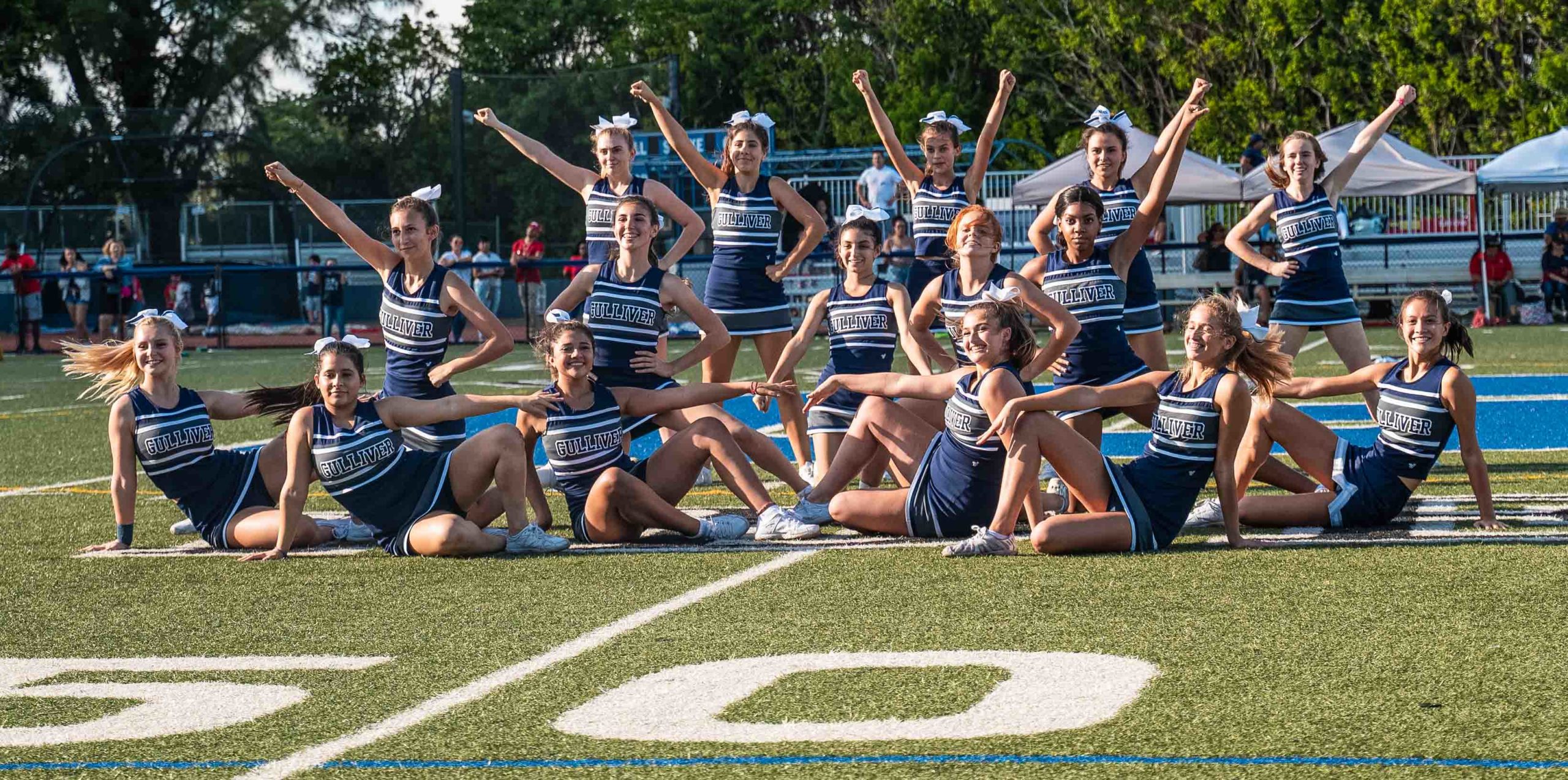 Cheerleading team posing for a group photo on the field