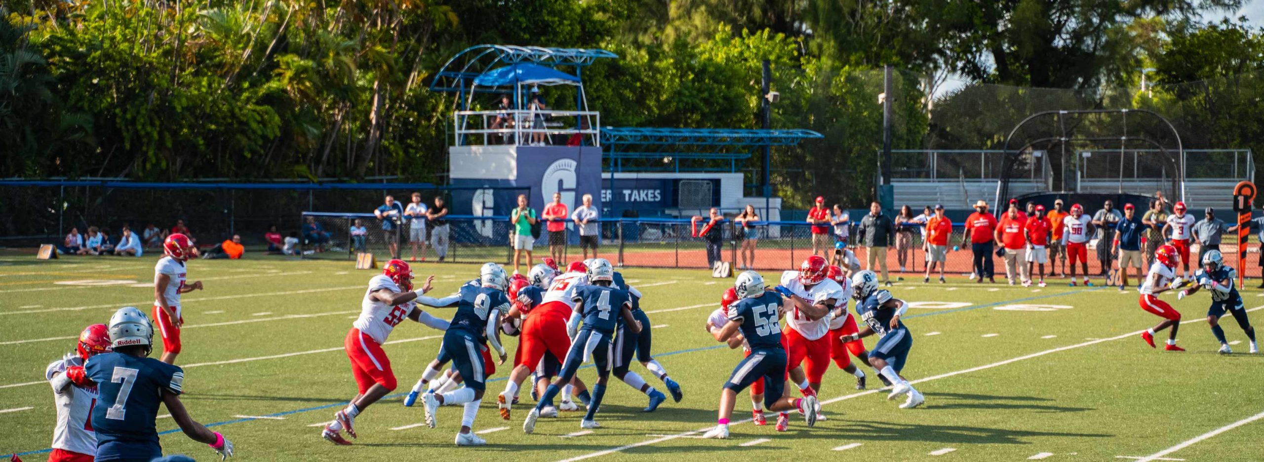 Football players running on field during a game