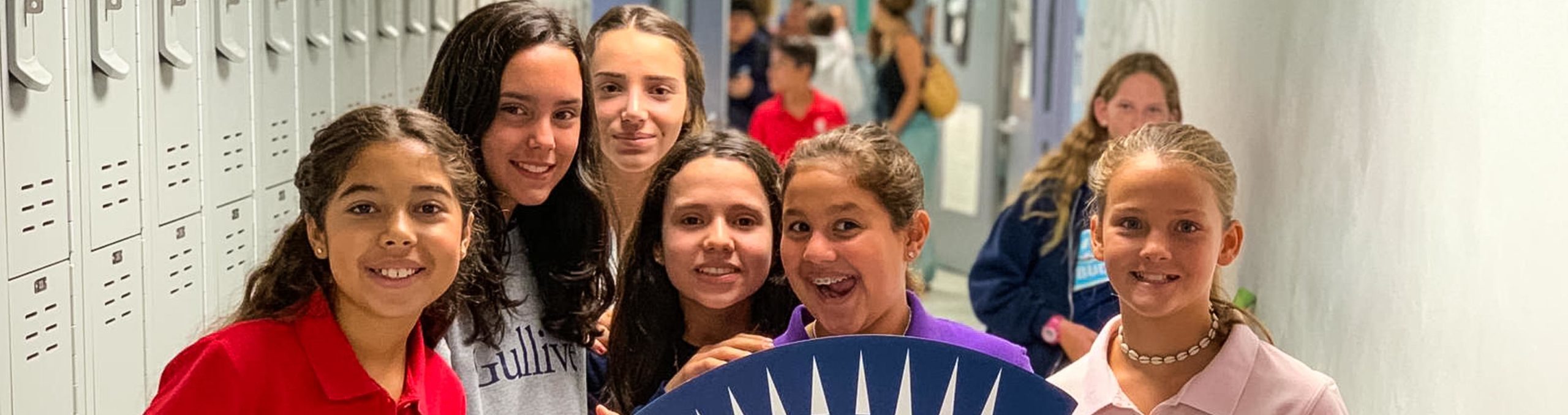 students holding a giant Gulliver foam logo