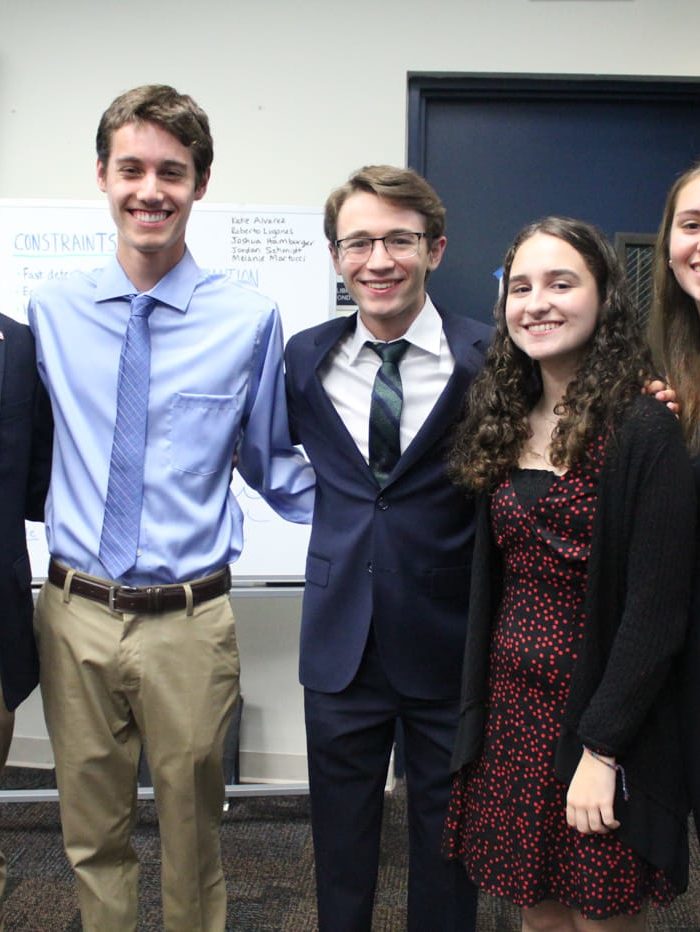 Five International Diplomacy & Law students standing in formal attire