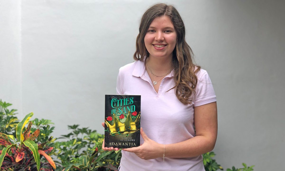 Isabel Cuellar '21 holding book.