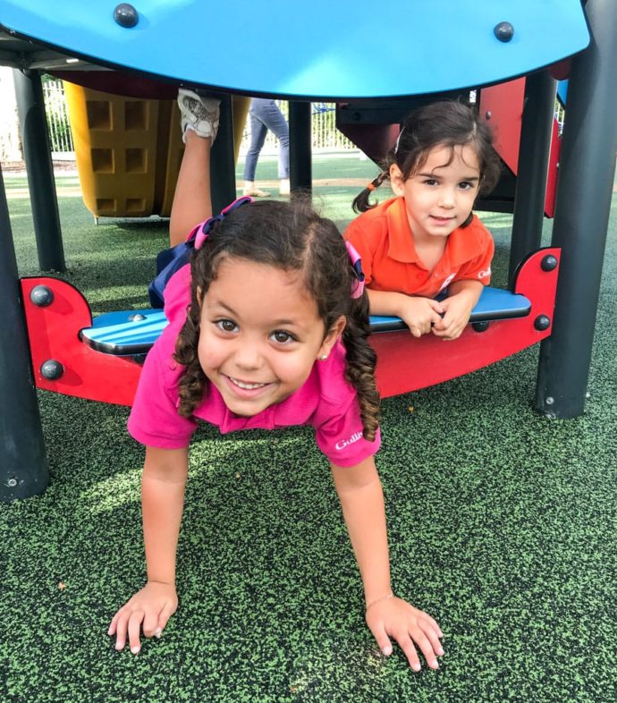 Lower school girl playing on the Kompan playground