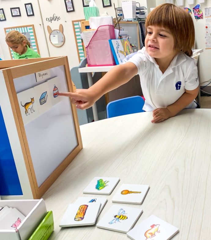 Young female student pointing to a whiteboard