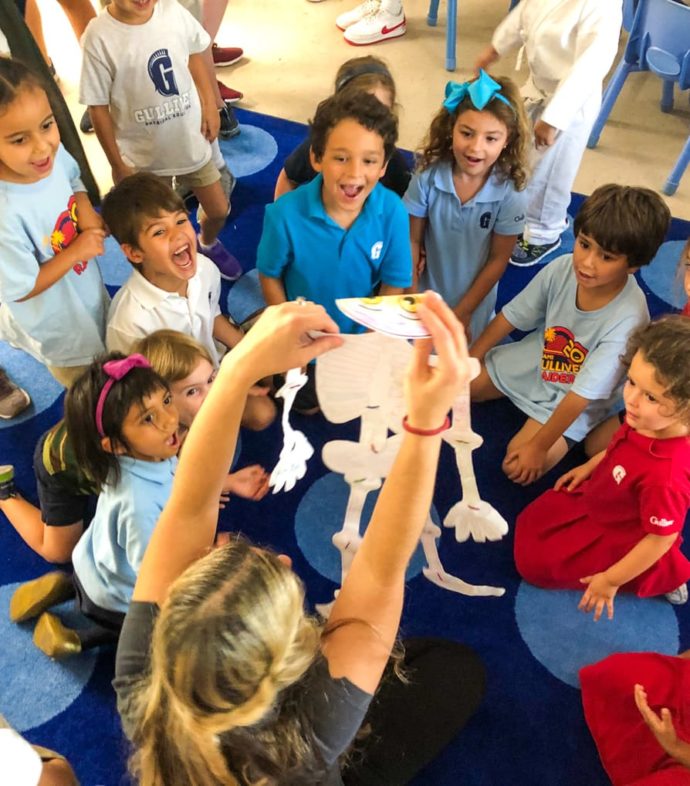 Teacher holding a paper skeleton