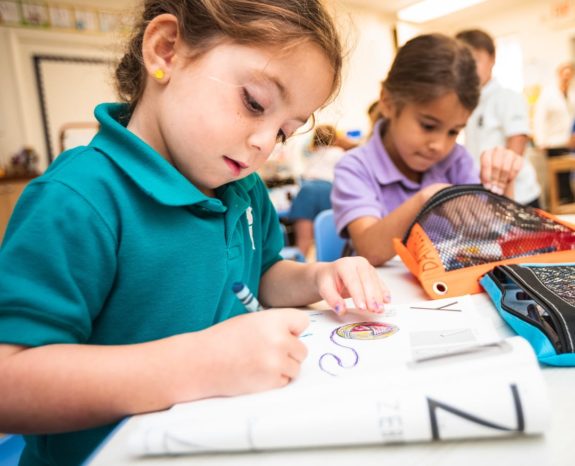 Female lower school student coloring