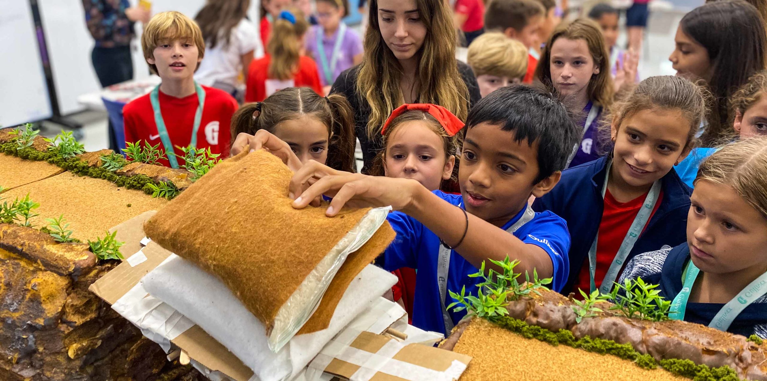 Middle school students testing a bridges strength
