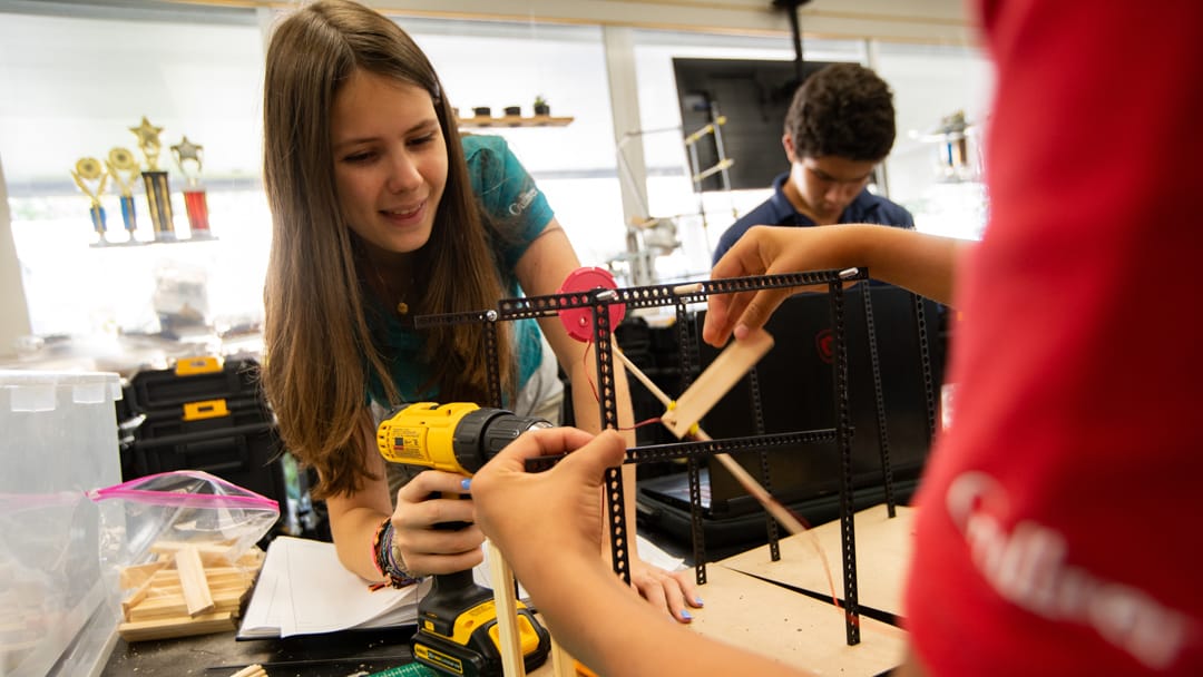 Middle school student using a drill