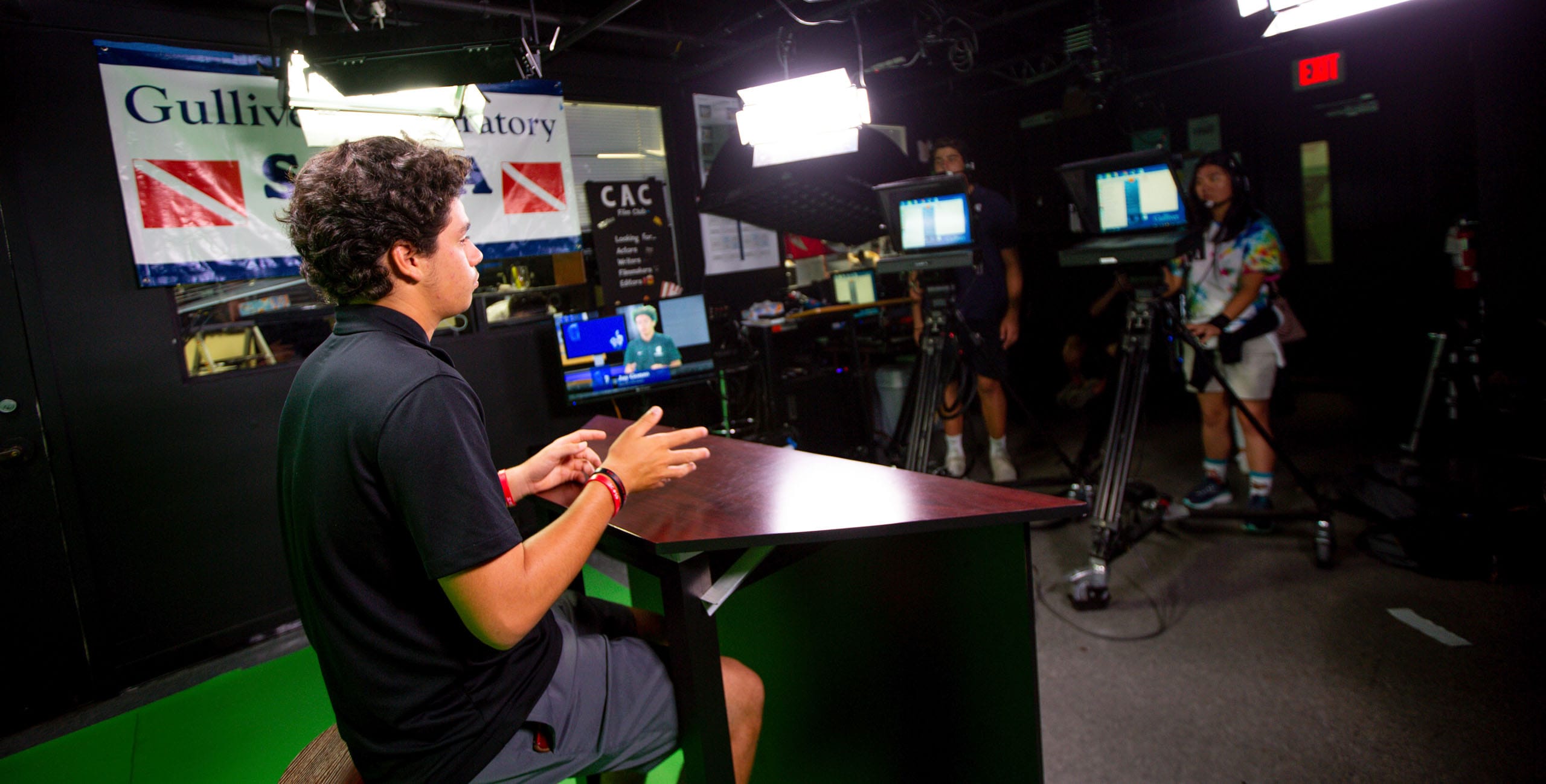 Upper school student recording a piece for the newsroom