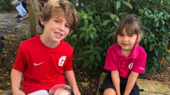 two lower school students reading.