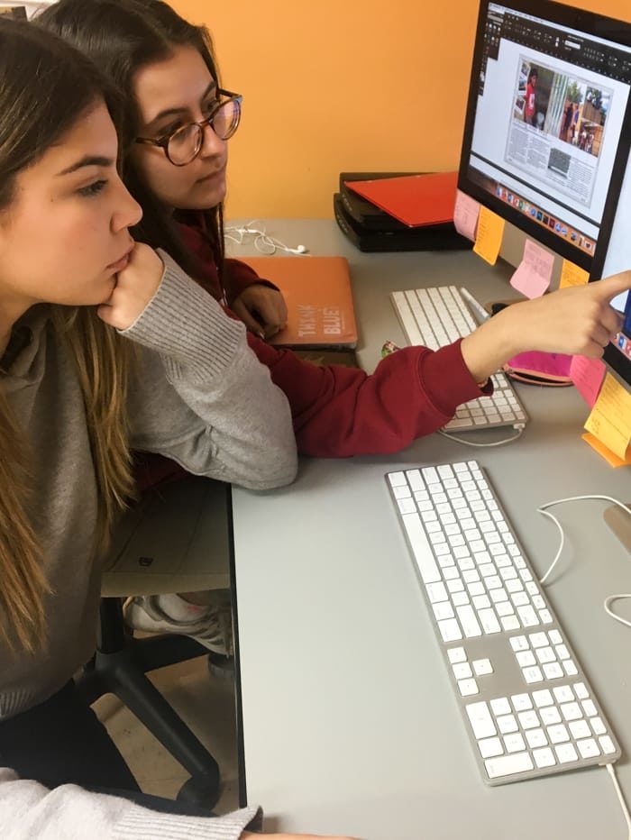 Two female students creating the Raider Voice articles