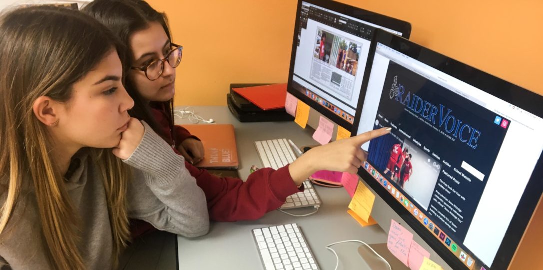 Two female students creating the Raider Voice articles