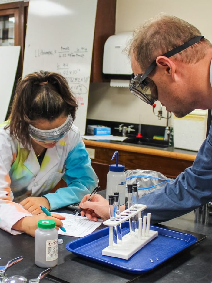 Science teacher with student in the lab