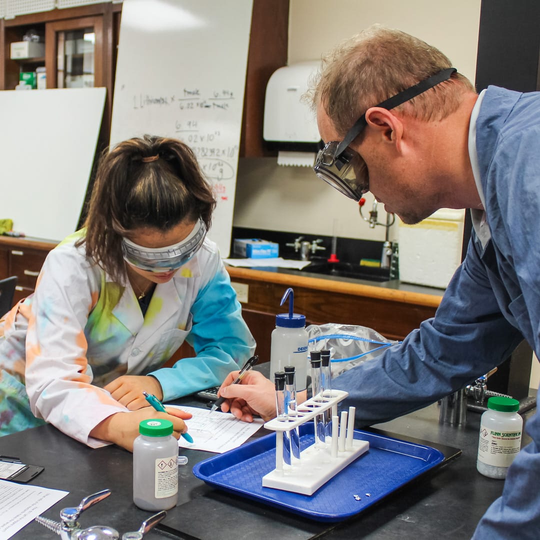 Science teacher with student in the lab