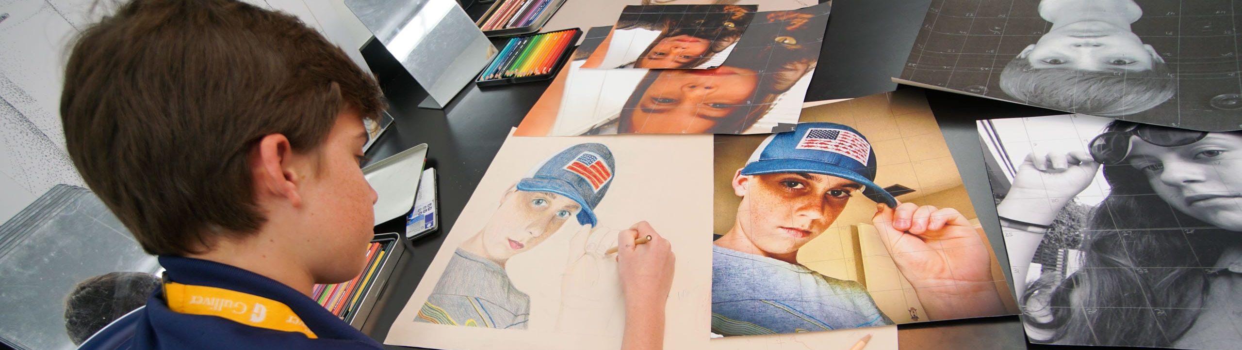Male student coloring a self portrait