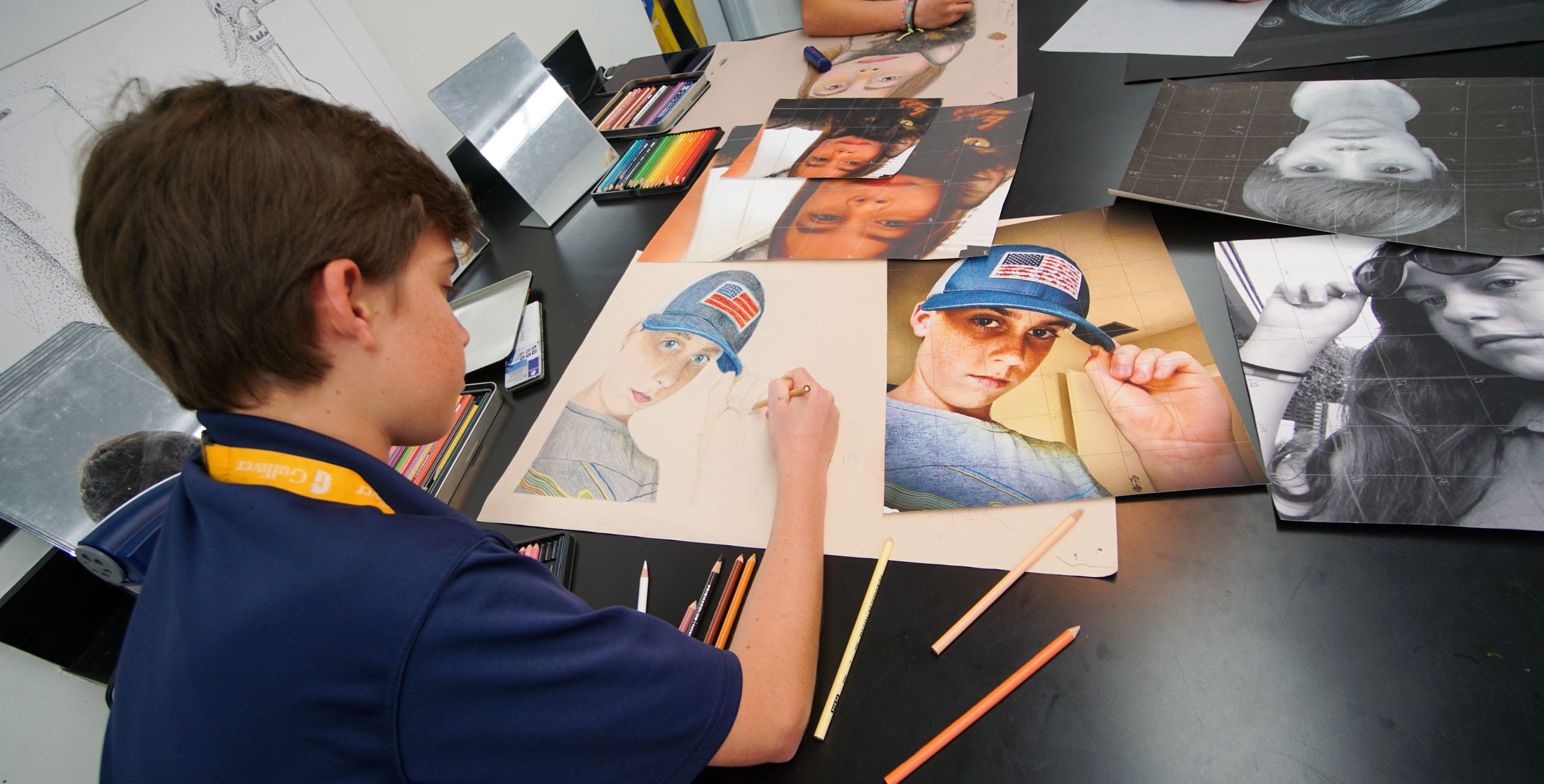 Male student coloring a self portrait