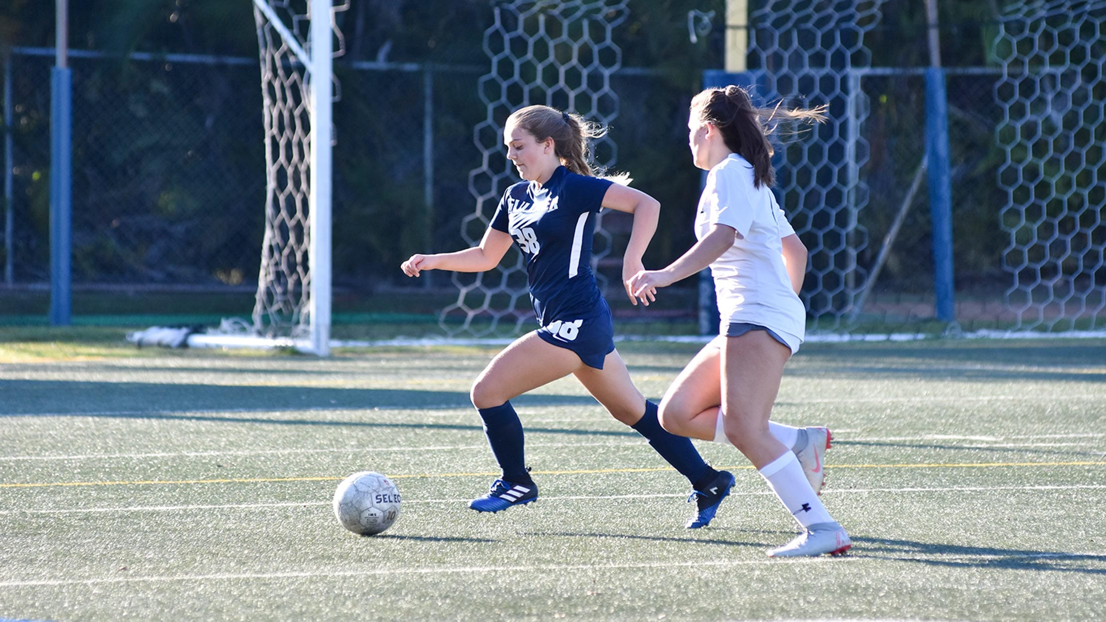 Girls playing in a soccer game