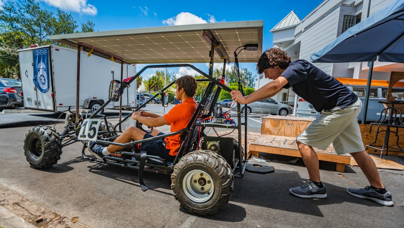 Two male students working on a solar vehicle project