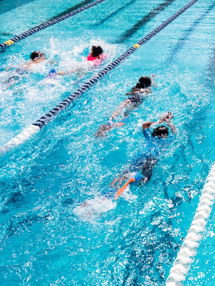 Middle school students swimming in lanes