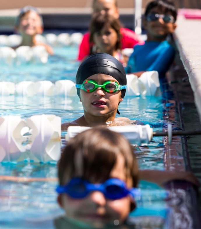 Young students swimming in the pool