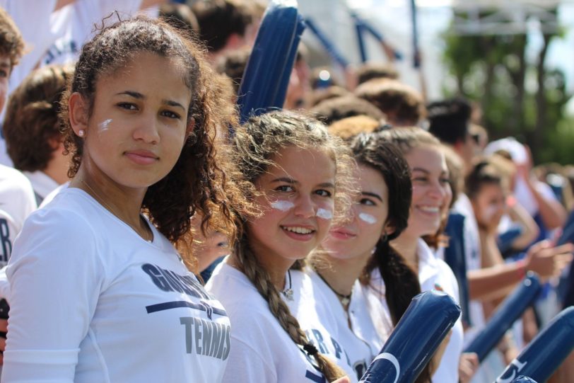 girls sitting dressed in white for the white out