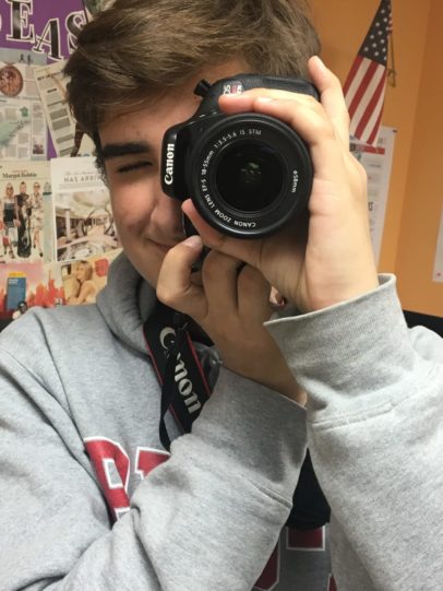 Male student taking photos for the yearbook