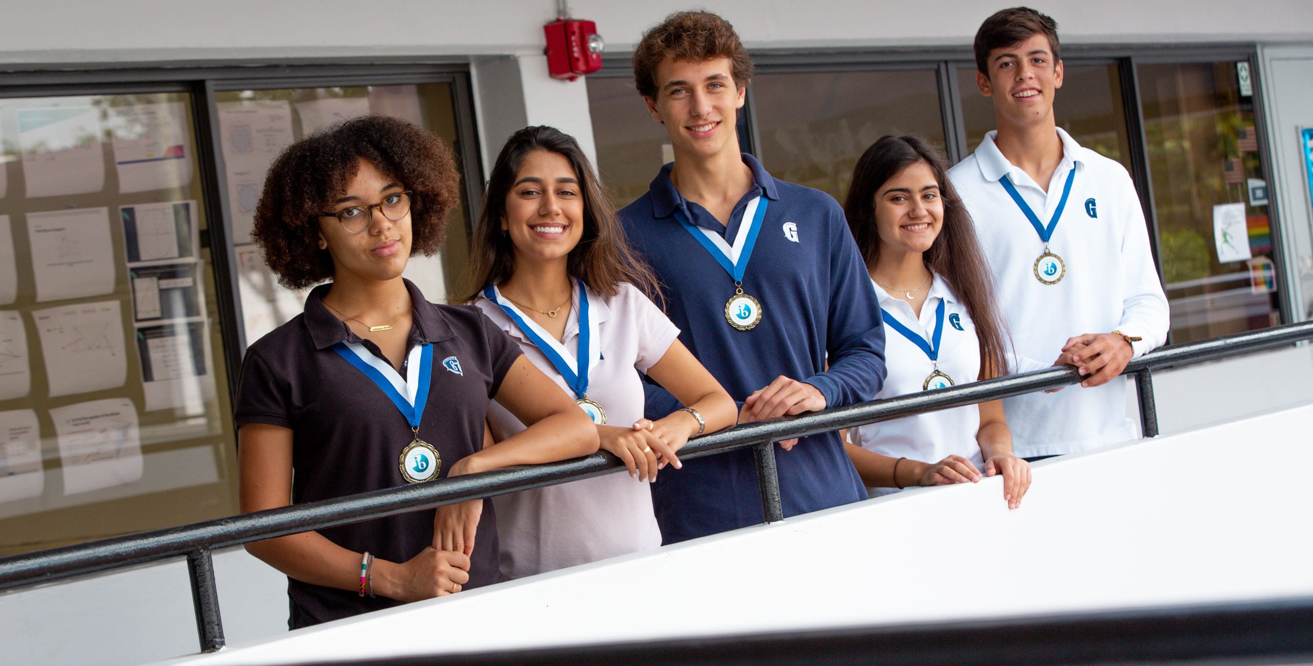 International Baccalaureate Program students standing by railing