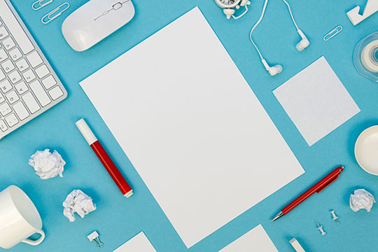 Office supplies arranged on a blue table