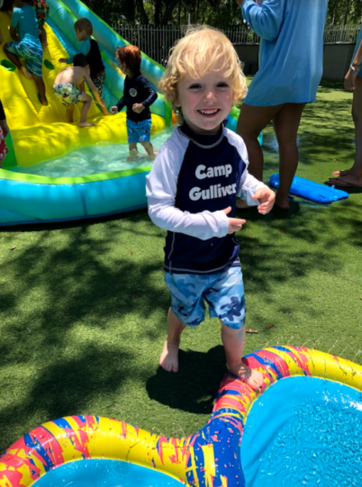 Young boy enjoying the water slide at Camp Gulliver.