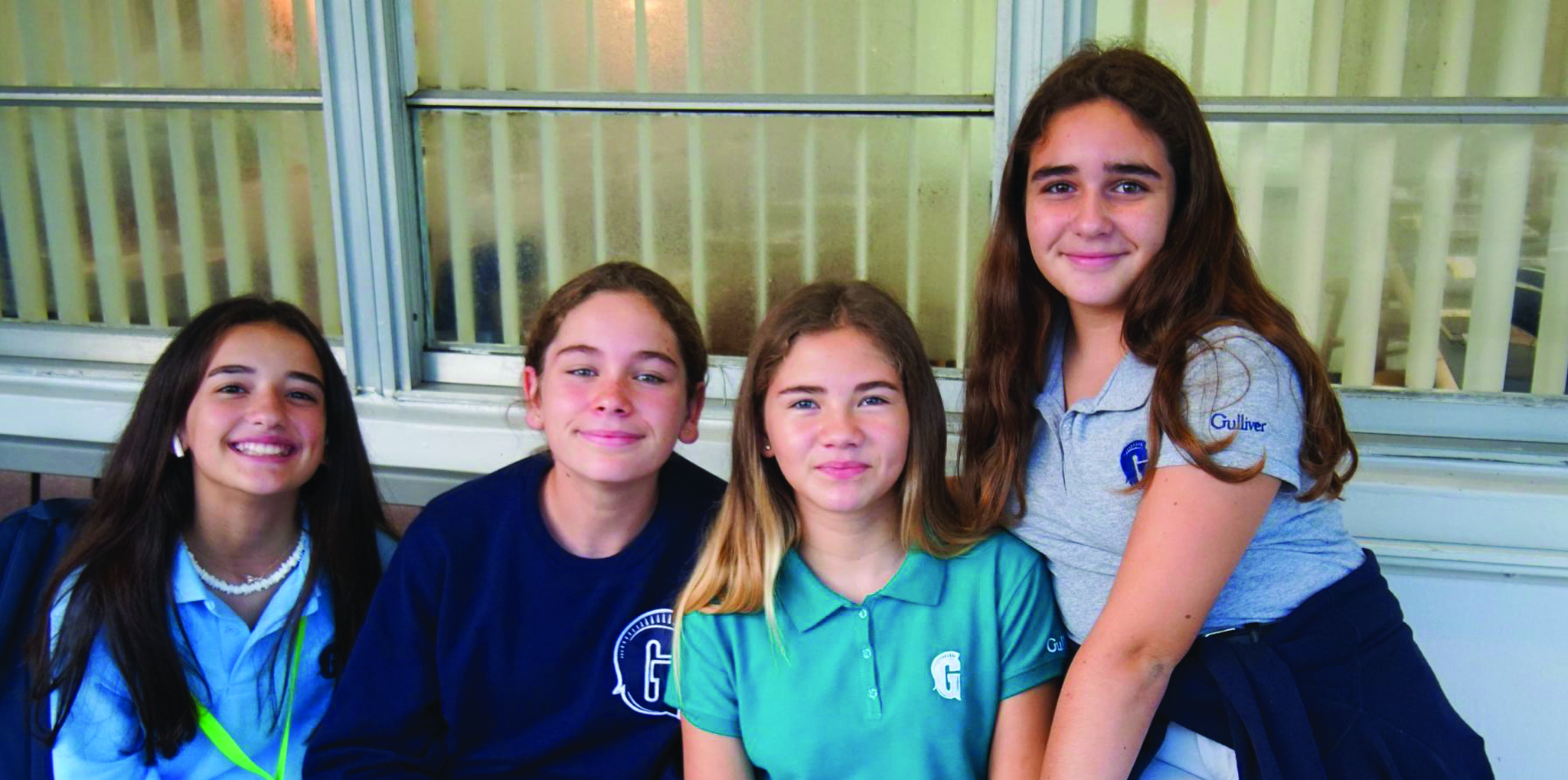 Four female students smiling