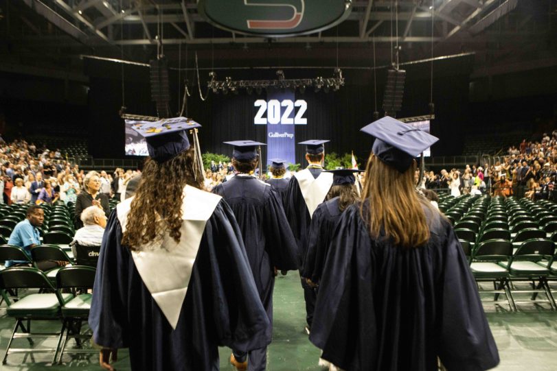 Students walking down the aisle commencement