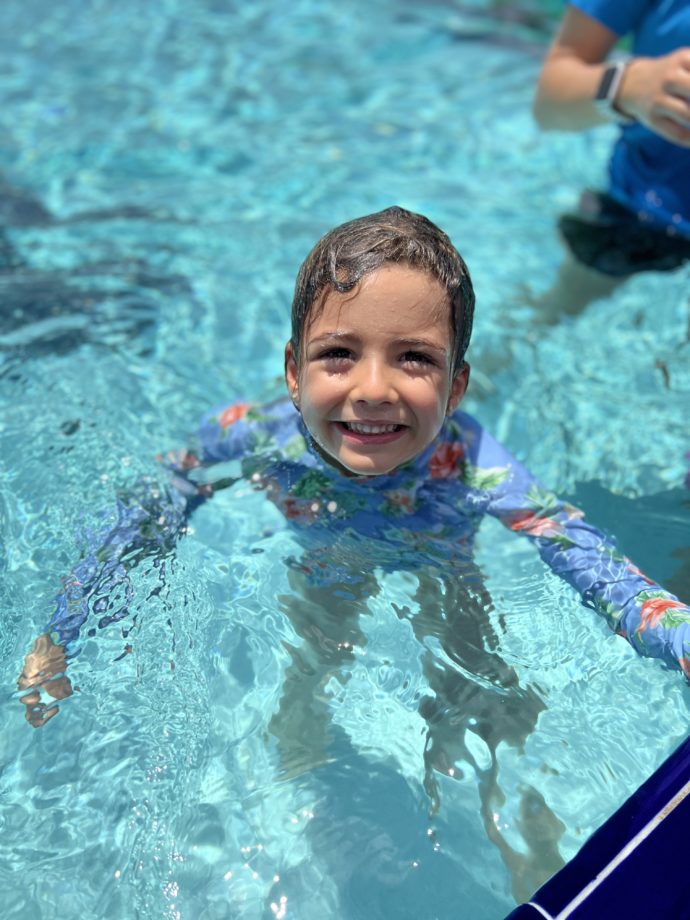 kid standing in swimming pool