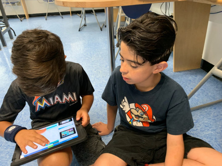 Two students using an ipad.