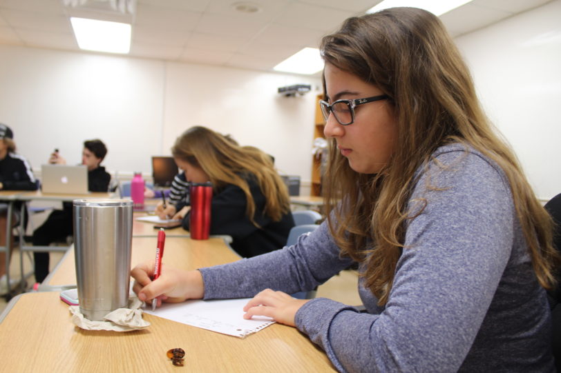 Student taking notes in class