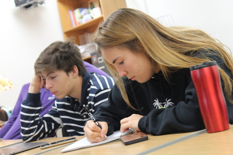 Students taking notes in class.