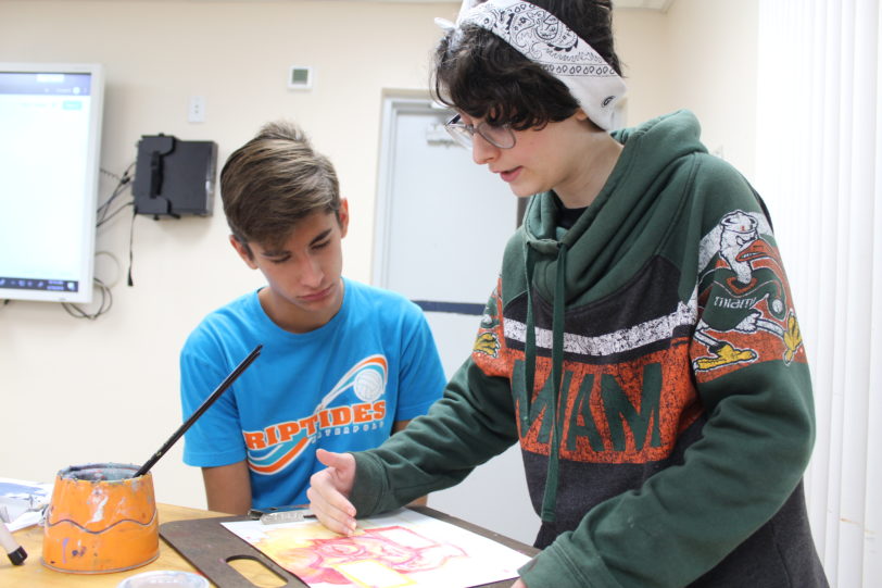 Two students working on an art project.