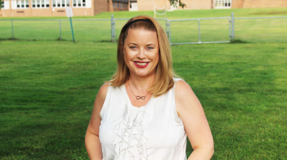 Woman standing in front of lawn