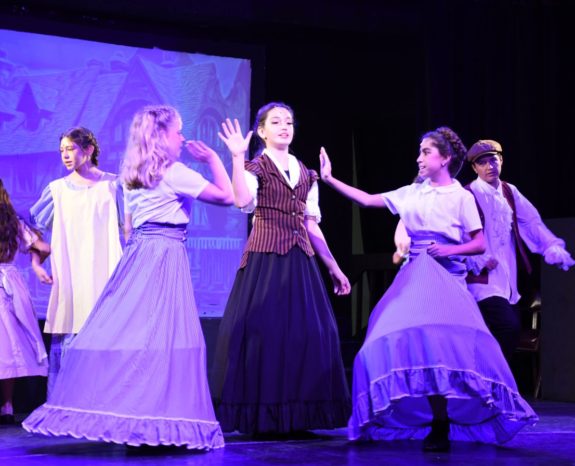 girls performing on stage at a musical theater camp