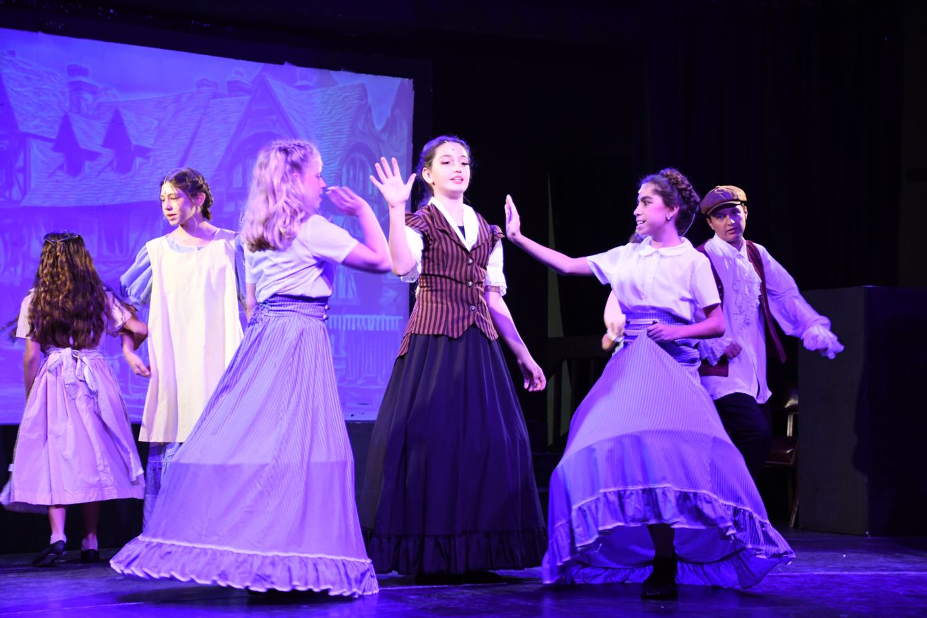 girls performing on stage at a musical theater camp